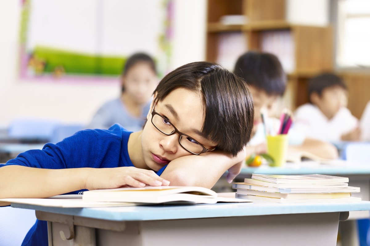 Child laying head on desk